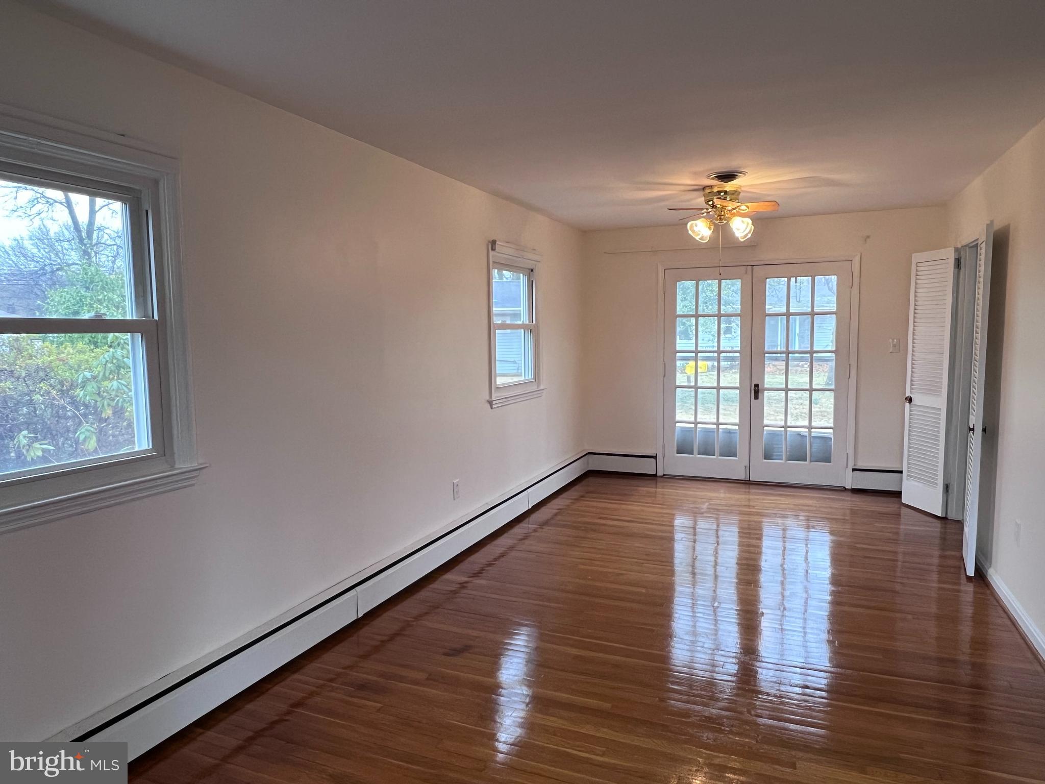 155 Sillery Bay Road Pasadena, MD 21122 - Photo 6 of 34 a view of an empty room with wooden floor and a window