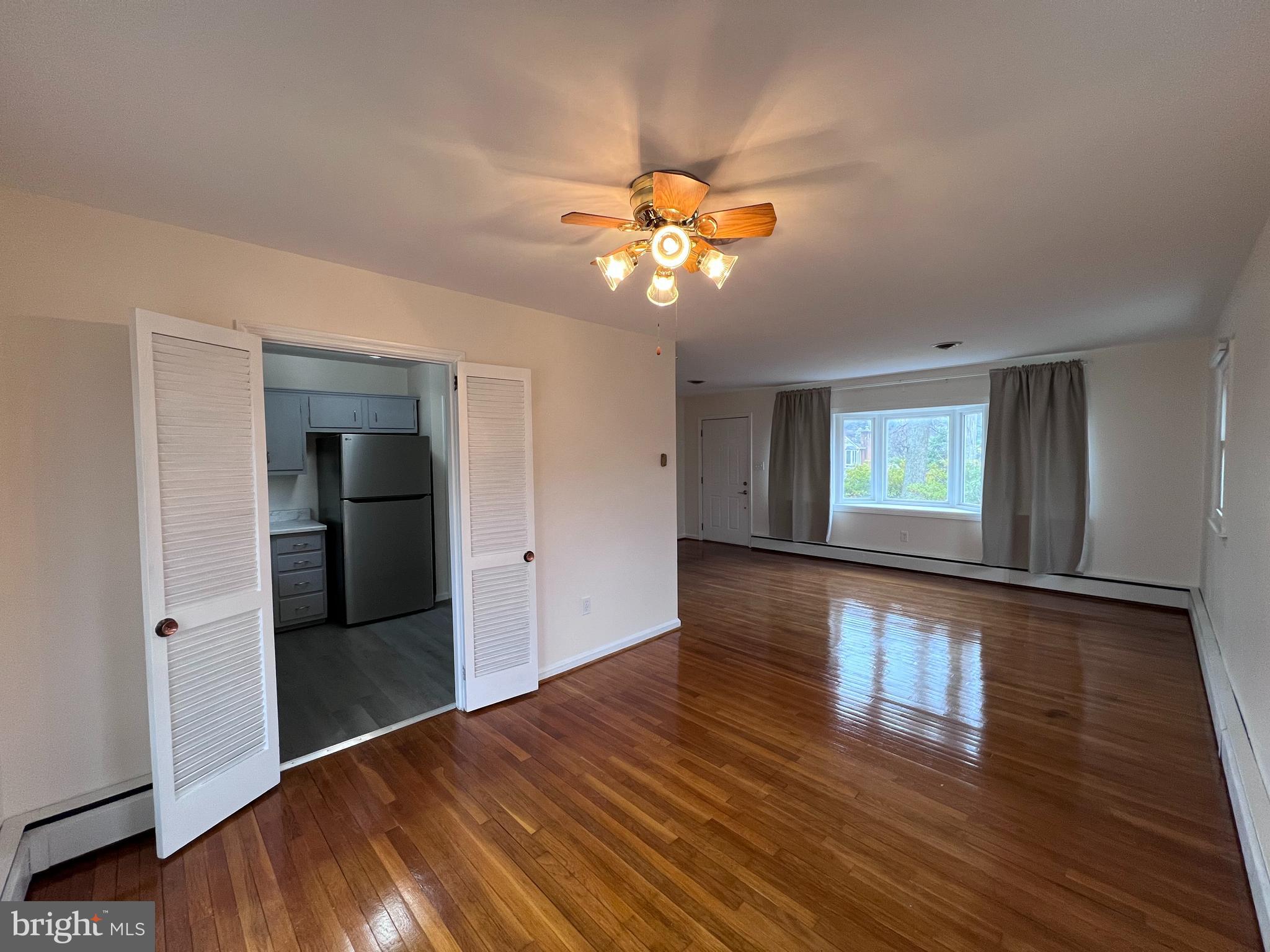 155 Sillery Bay Road Pasadena, MD 21122 - Photo 7 of 34 a view of an empty room with window and wooden floor
