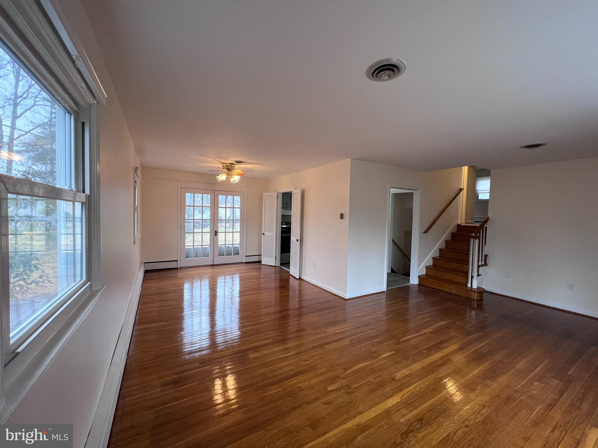 155 Sillery Bay Road Pasadena, MD 21122 - Photo 8 of 34 a view of an empty room with wooden floor and a window