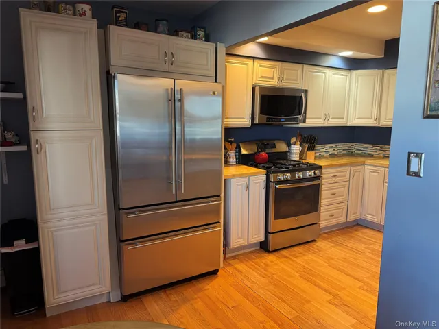 a kitchen with stainless steel appliances a refrigerator stove and microwave