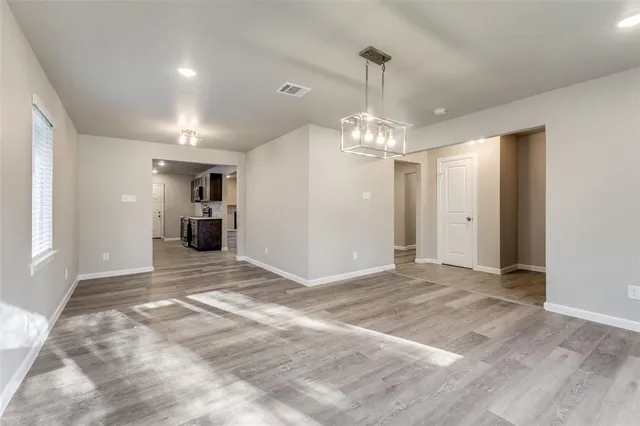 a view of a kitchen with a sink and a chandelier