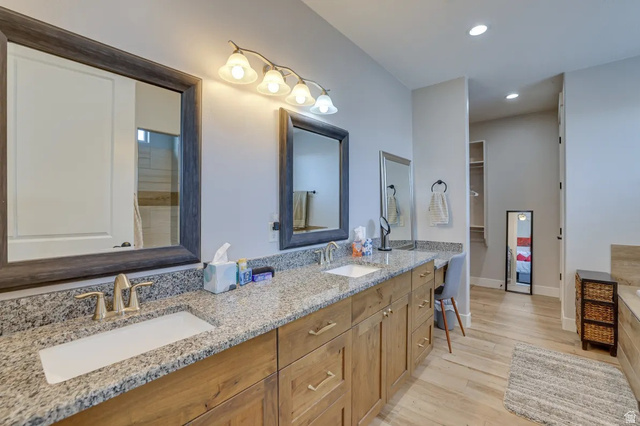 217 West Terrace Circle Toquerville, UT 84774 - Photo 7 of 25 Bathroom with double vanity, recessed lighting, a walk in closet, and light wood finished floors