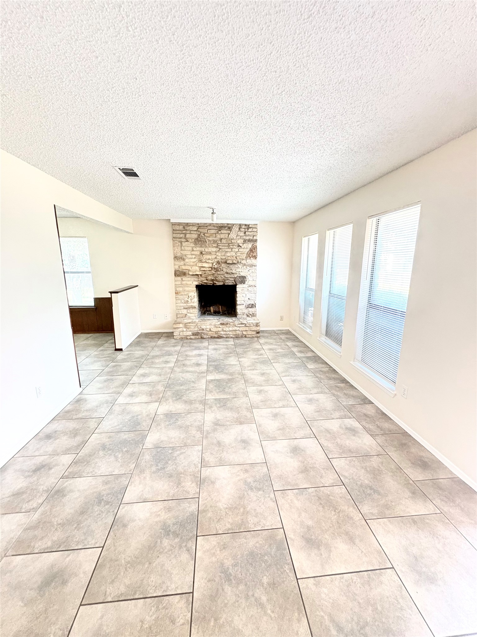 1212 Leander Road, Unit A Georgetown, TX 78628 - Photo 7 of 20 A spacious living area with a stone fireplace and ample natural light.