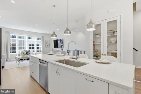 a kitchen with stainless steel appliances granite countertop a stove a microwave and a white cabinets