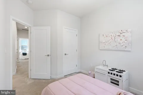 a view of living room with furniture and baby crib