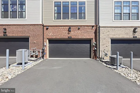 a front view of a house with yard and garage