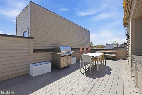 a view of a chairs and table on the deck with wooden floor