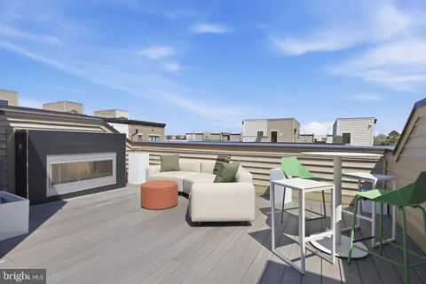 a balcony with furniture and a fireplace