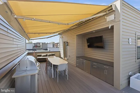 a balcony with a table and chairs