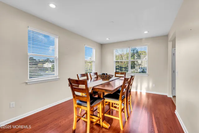 a dining room with furniture and wooden floor