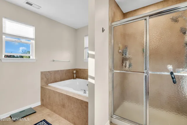 a bathroom with a tub and shower