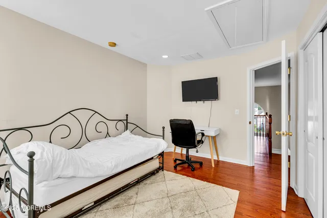 a bedroom with a bed and a tv