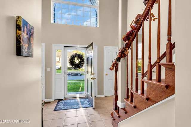 a view of an entryway with wooden floor and door