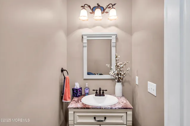 a bathroom with a sink mirror and vanity