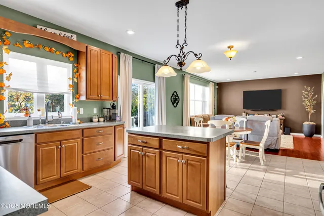 a large kitchen with a counter space a sink appliances and a counter top space