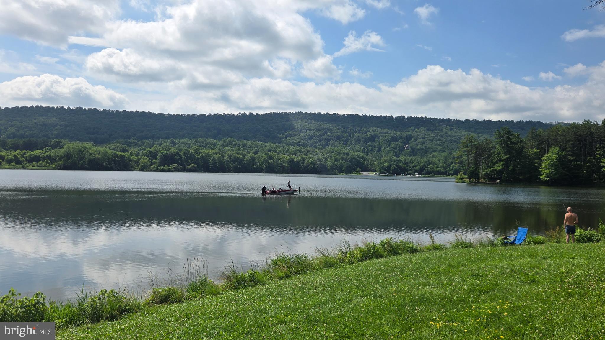 212 Thickhead Mountain Road Centre Hall, PA 16828 - Photo 11 of 28 Serene lake view with lush green hills.