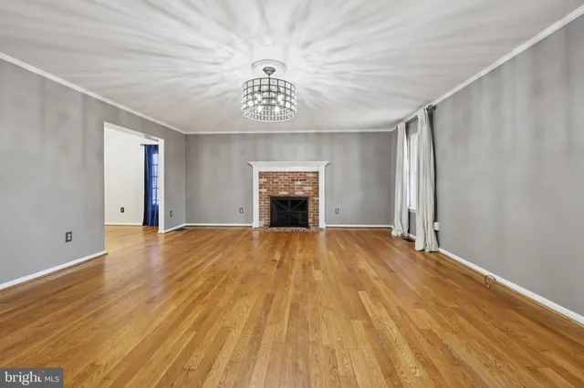 a view of a room with wooden floor door and windows