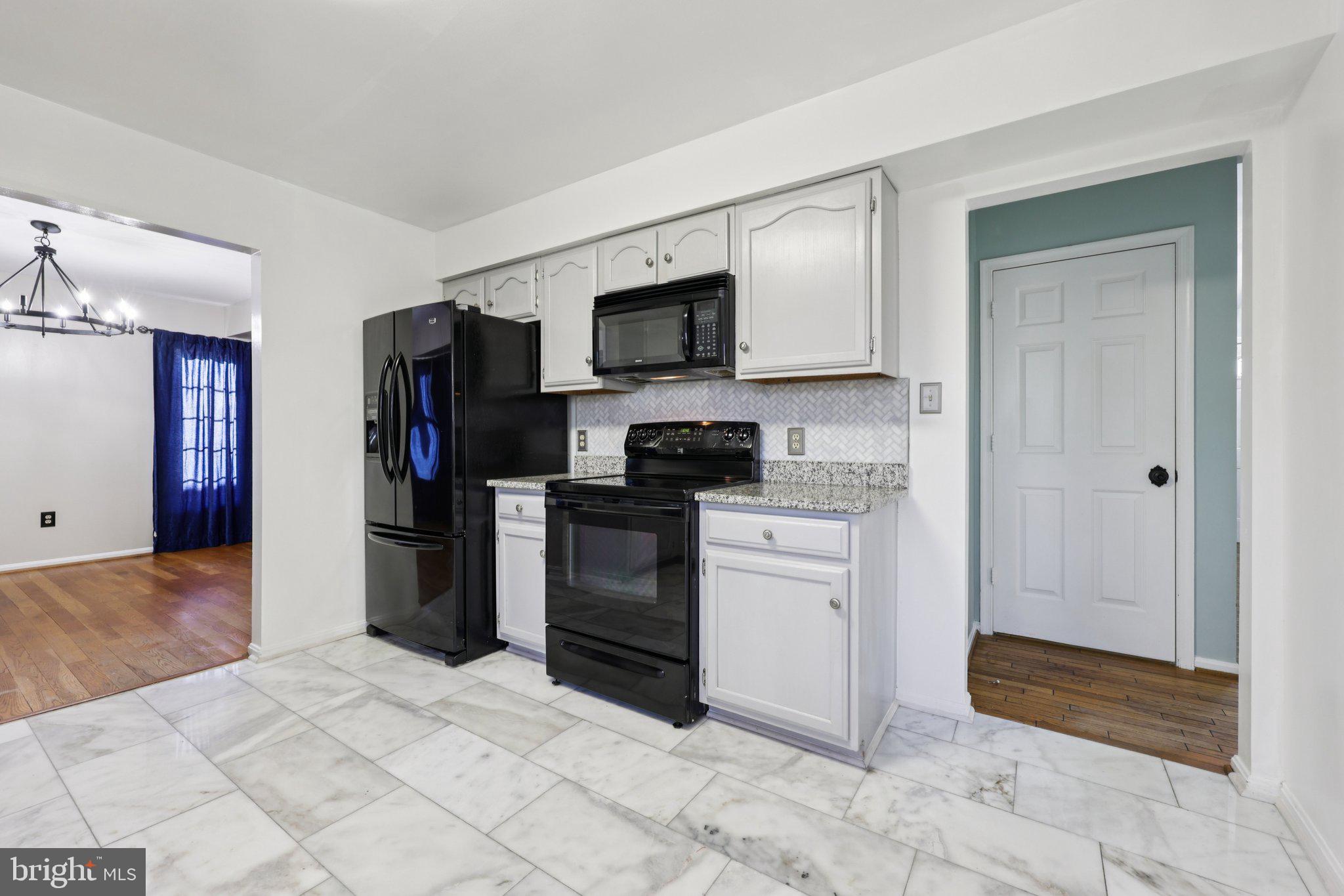 13445 Blackwells Mill Road Goldvein, VA 22720 - Photo 25 of 95 a kitchen with stainless steel appliances granite countertop a refrigerator and a stove top oven