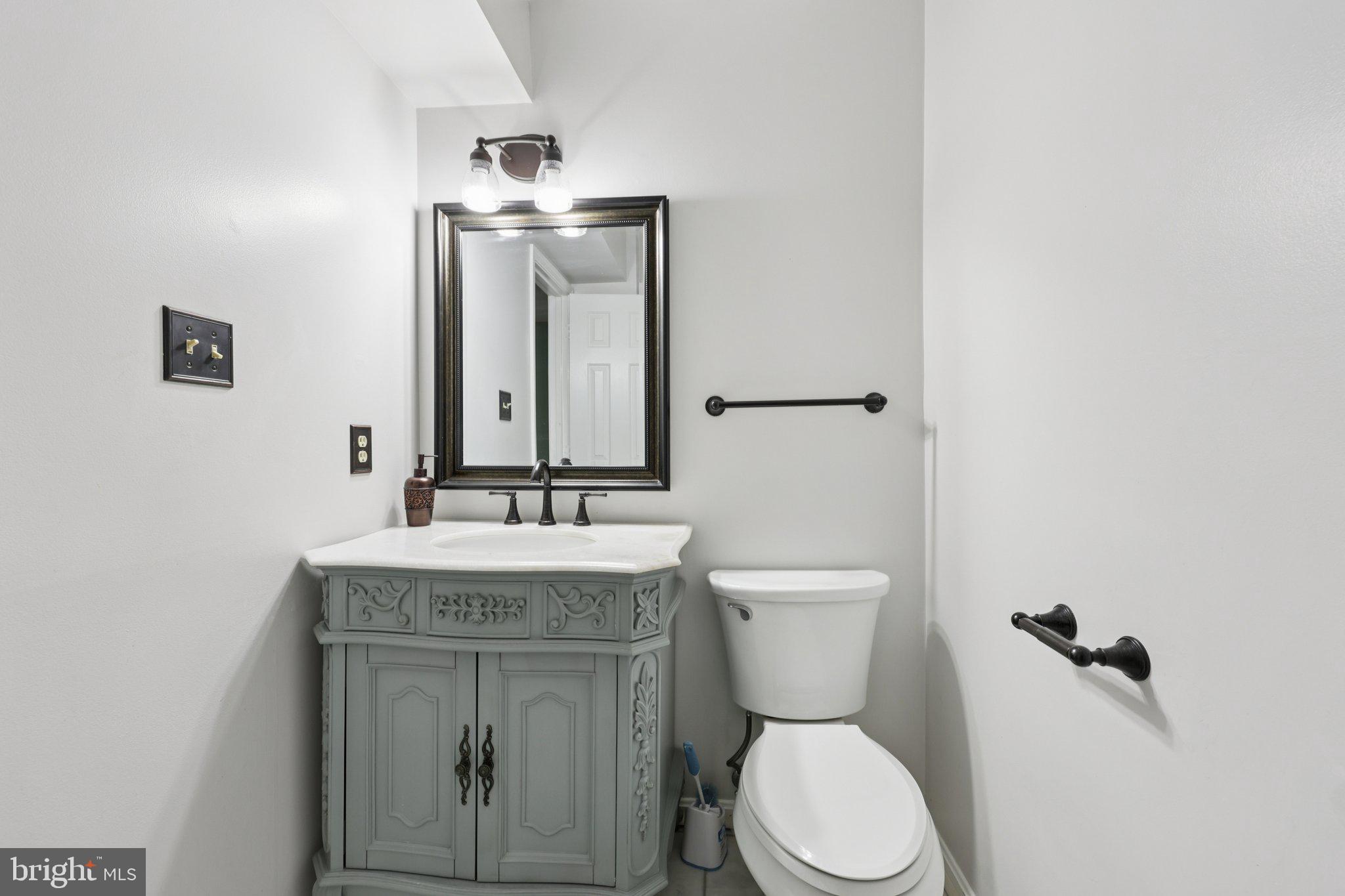 13445 Blackwells Mill Road Goldvein, VA 22720 - Photo 26 of 95 a bathroom with a granite countertop toilet sink and mirror