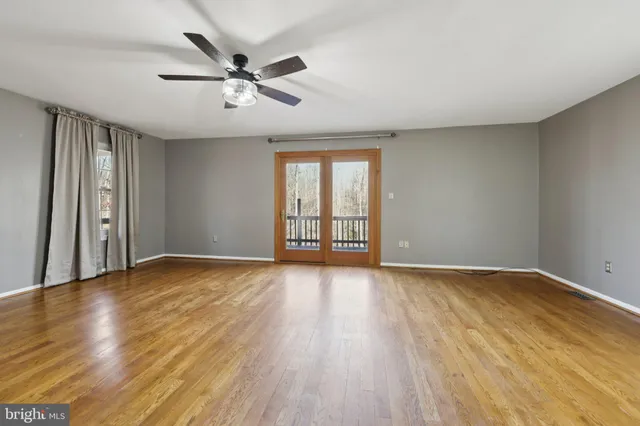 a view of a livingroom with wooden floor and window