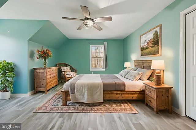 a living room with furniture a wooden floor and a chandelier