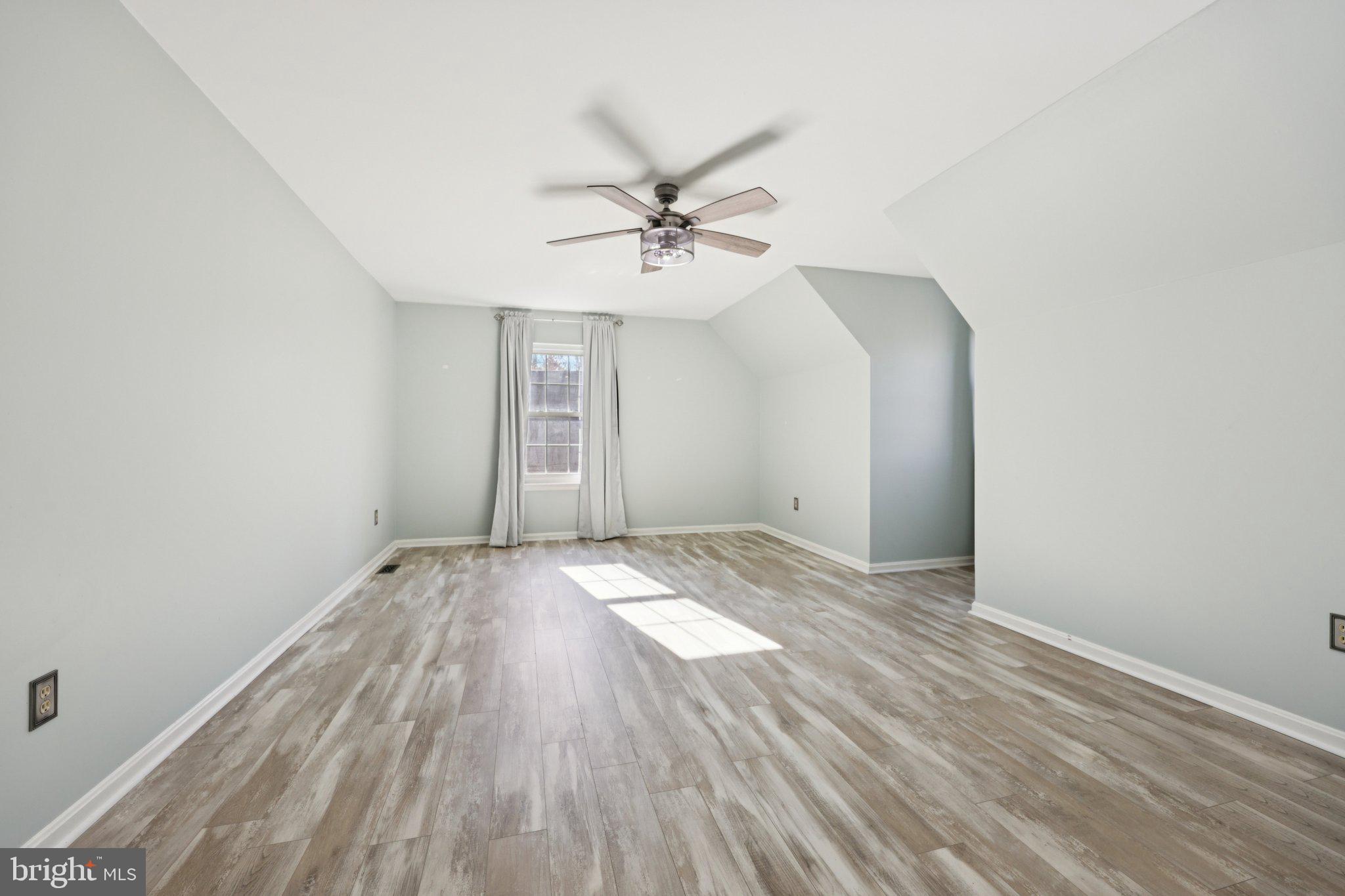 13445 Blackwells Mill Road Goldvein, VA 22720 - Photo 43 of 95 an empty room with wooden floor fan and windows