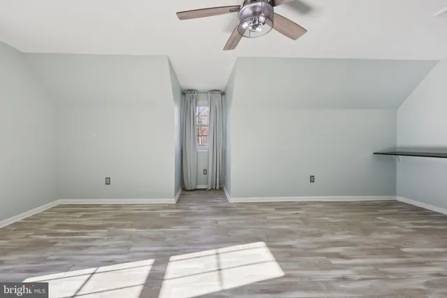 a view of a dry yard with wooden floor and fence