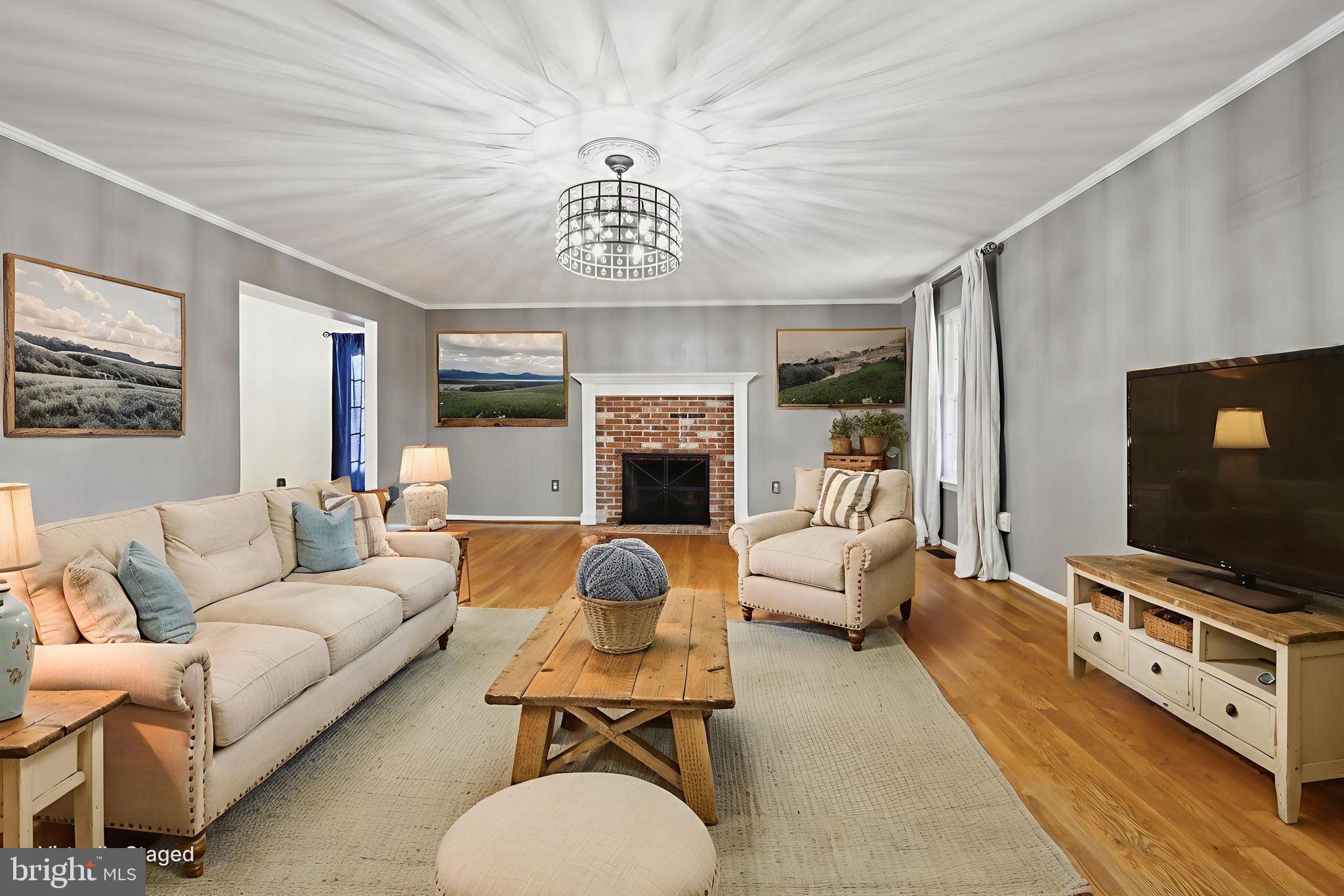 13445 Blackwells Mill Road Goldvein, VA 22720 - Photo 5 of 95 a living room with furniture a flat screen tv and a fireplace