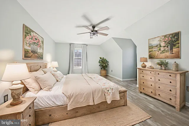 a living room with furniture a wooden floor and a chandelier
