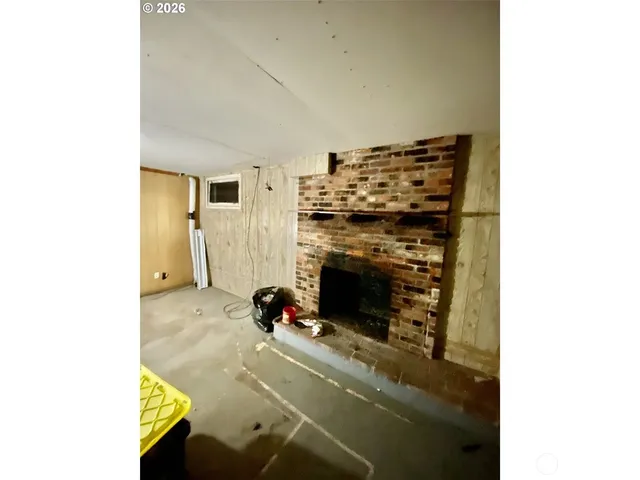 a room with lots of white furniture and clutter