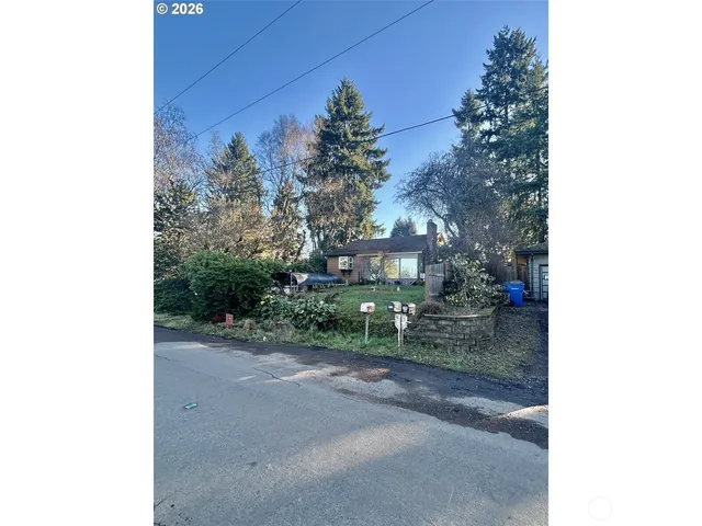 a view of a house with a yard and pathway