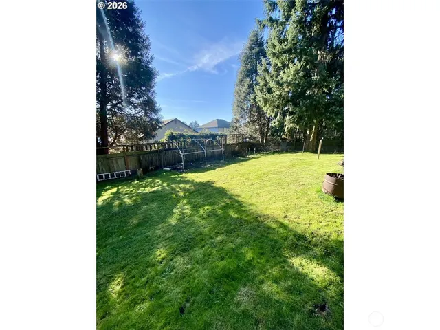 a swimming pool with some trees in the background