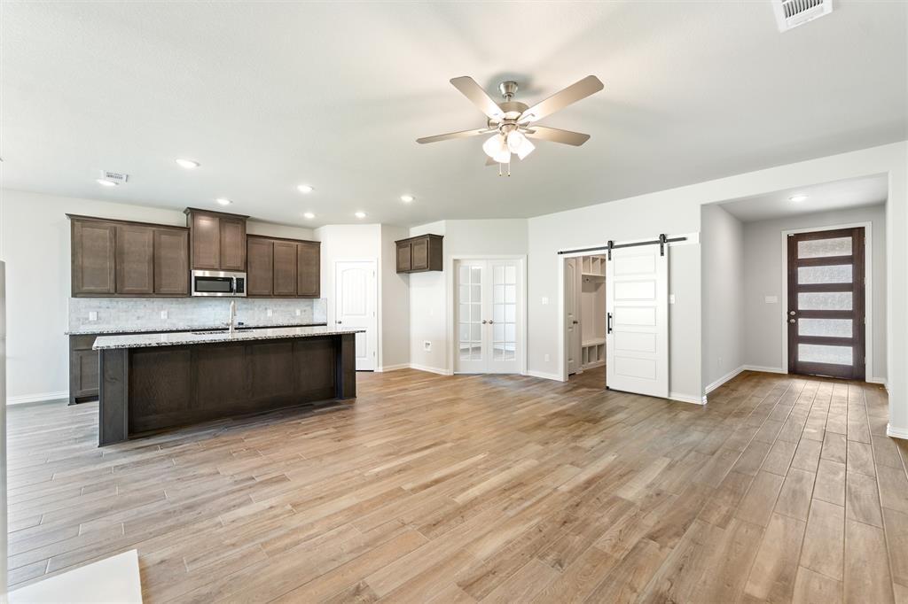 541 Mitchell Boulevard Weatherford, TX 76087 - Photo 10 of 30 a view of kitchen with granite countertop cabinets and refrigerator