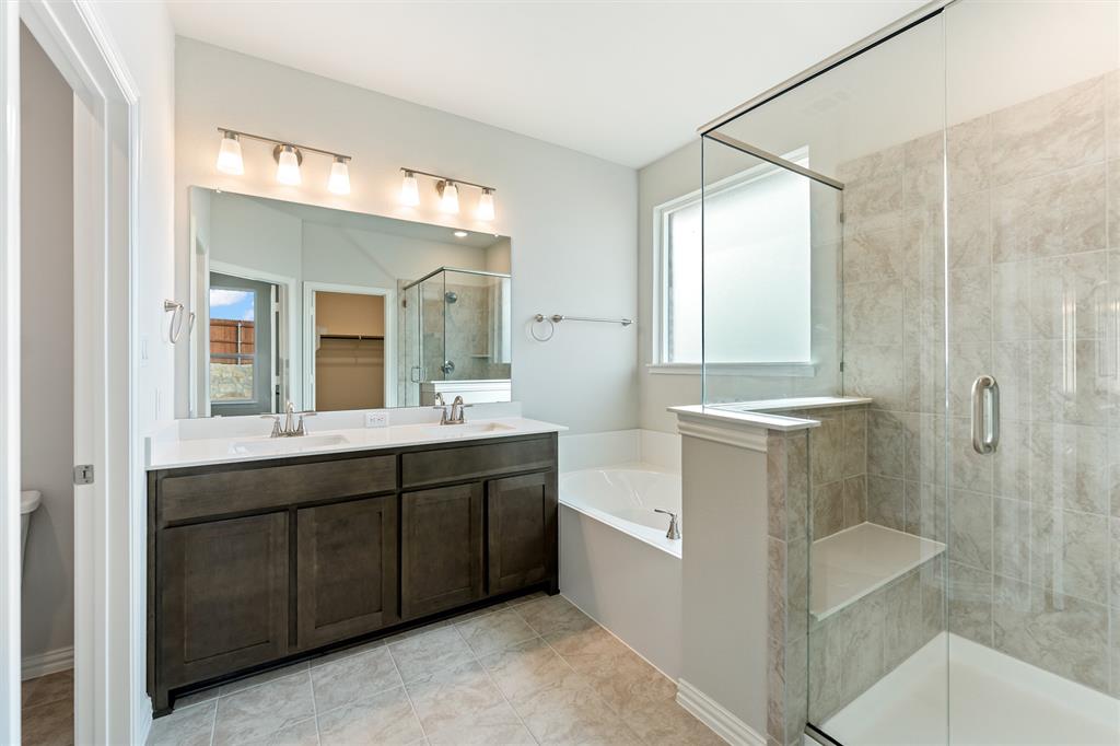 541 Mitchell Boulevard Weatherford, TX 76087 - Photo 13 of 30 a spacious bathroom with a double vanity sink mirror and shower