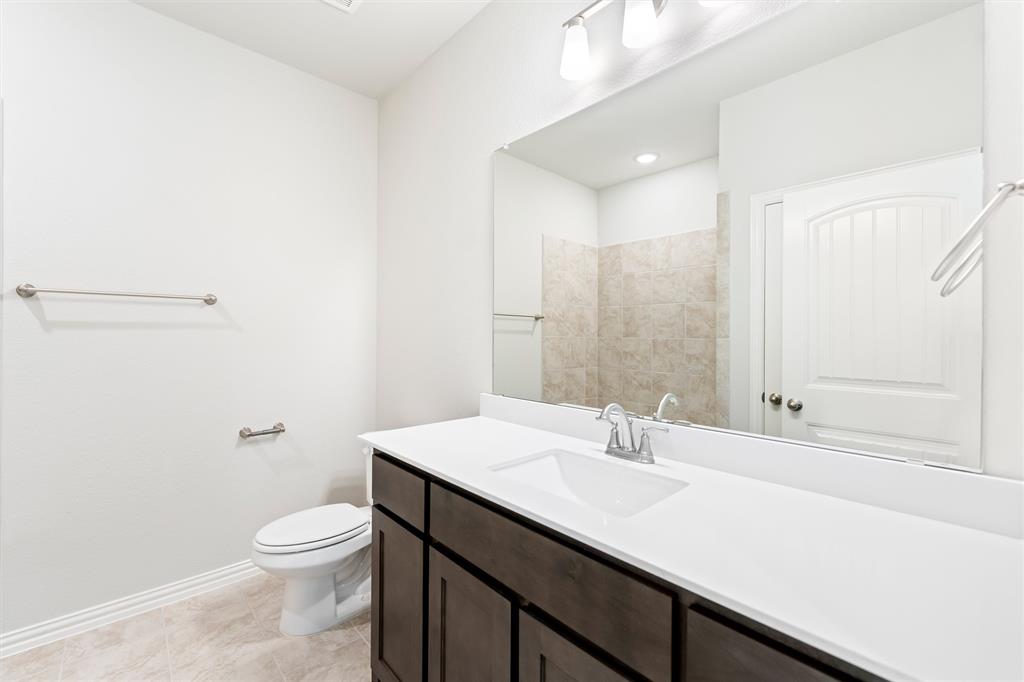 541 Mitchell Boulevard Weatherford, TX 76087 - Photo 18 of 30 a bathroom with a sink a toilet and shower