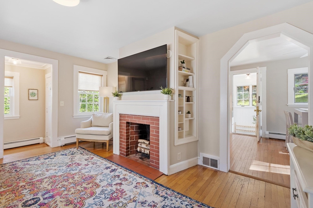 25 Naples Road Melrose, MA 02176 - Photo 6 of 36 a living room with furniture and a fireplace