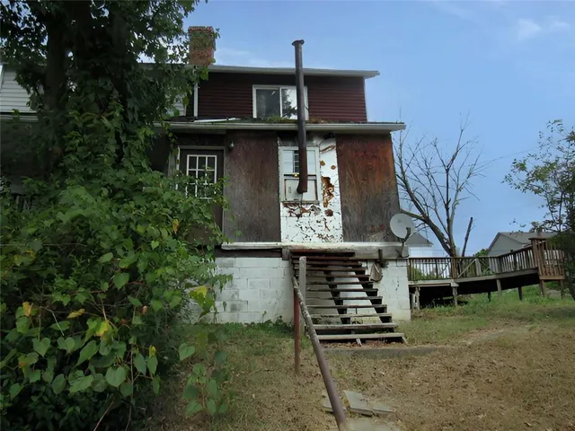 a front view of house with a garden