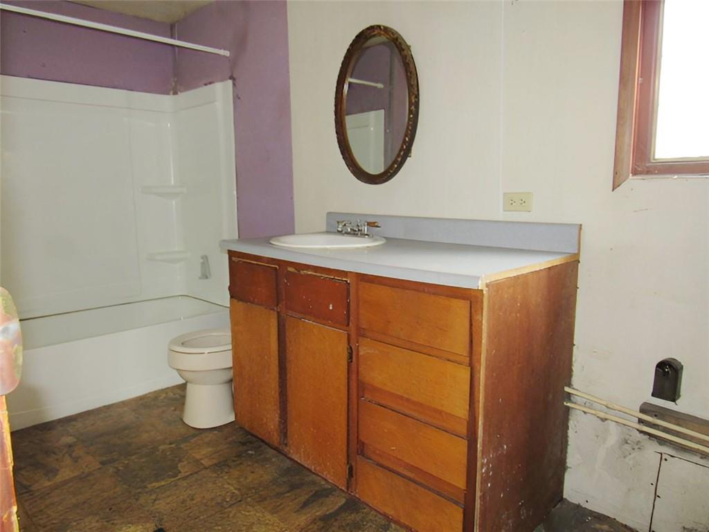128 Shoaf Road Smithfield, PA 15478 - Photo 5 of 12 a bathroom with a toilet a sink and a mirror