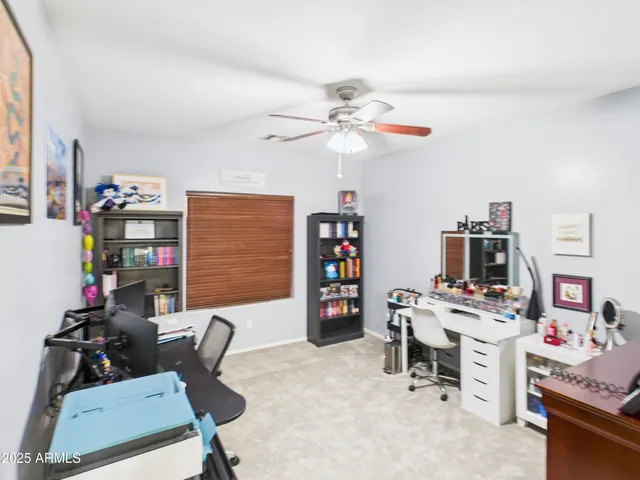a view of a workspace with furniture and a window
