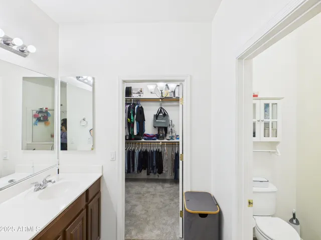 a en suite bathroom with a sink double vanity and a toilet