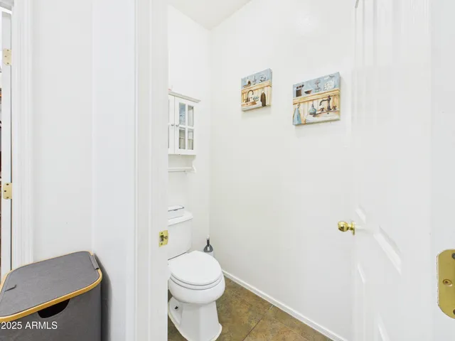 a white toilet sitting next to a bathroom sink
