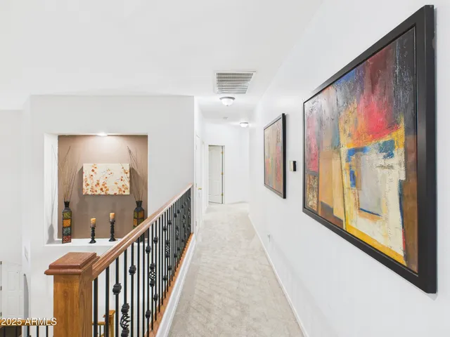 a view of a hallway with wooden floor and windows