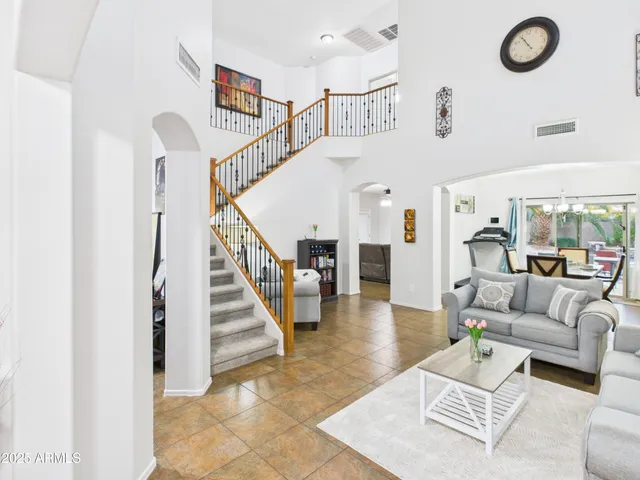 a living room with furniture and stairs
