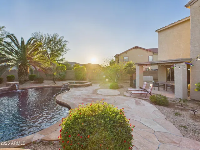 a view of a house with backyard and sitting area