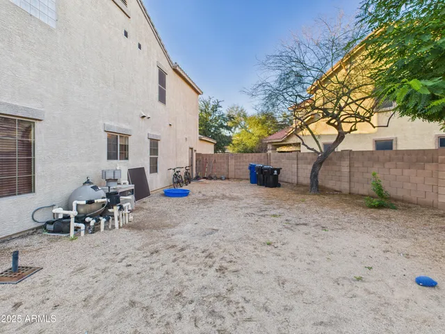 a backyard of a house with table and chairs