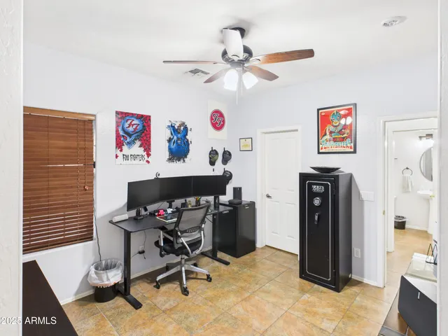 a workspace with furniture and a ceiling fan