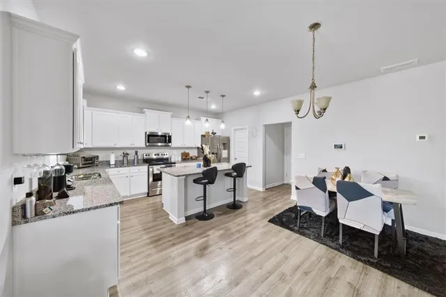 a kitchen with refrigerator cabinets and wooden floor