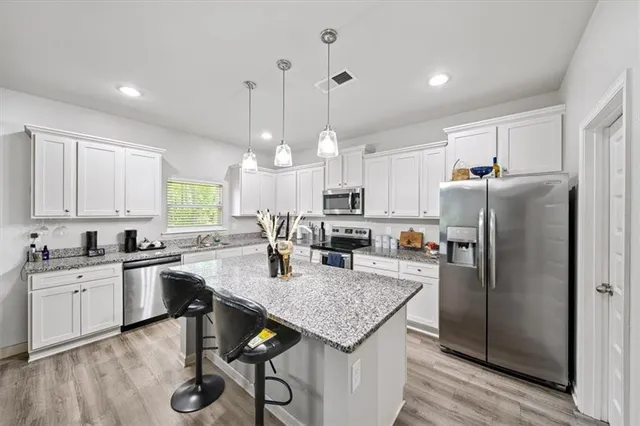 a kitchen with a stove a sink and a refrigerator