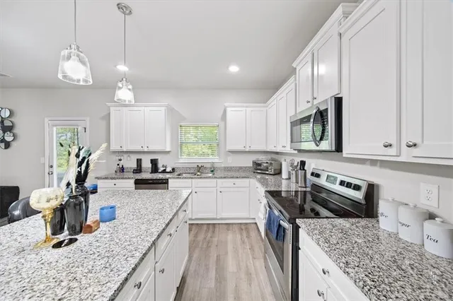 a kitchen with a counter top space appliances and cabinets