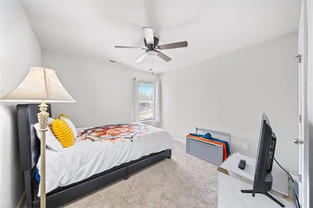 a bedroom with a bed and window